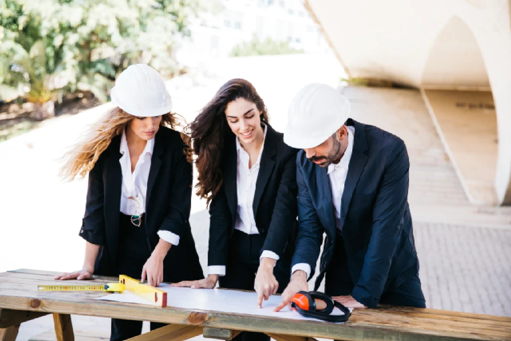 A team of project managers and golf architects reviewing plans on a construction site