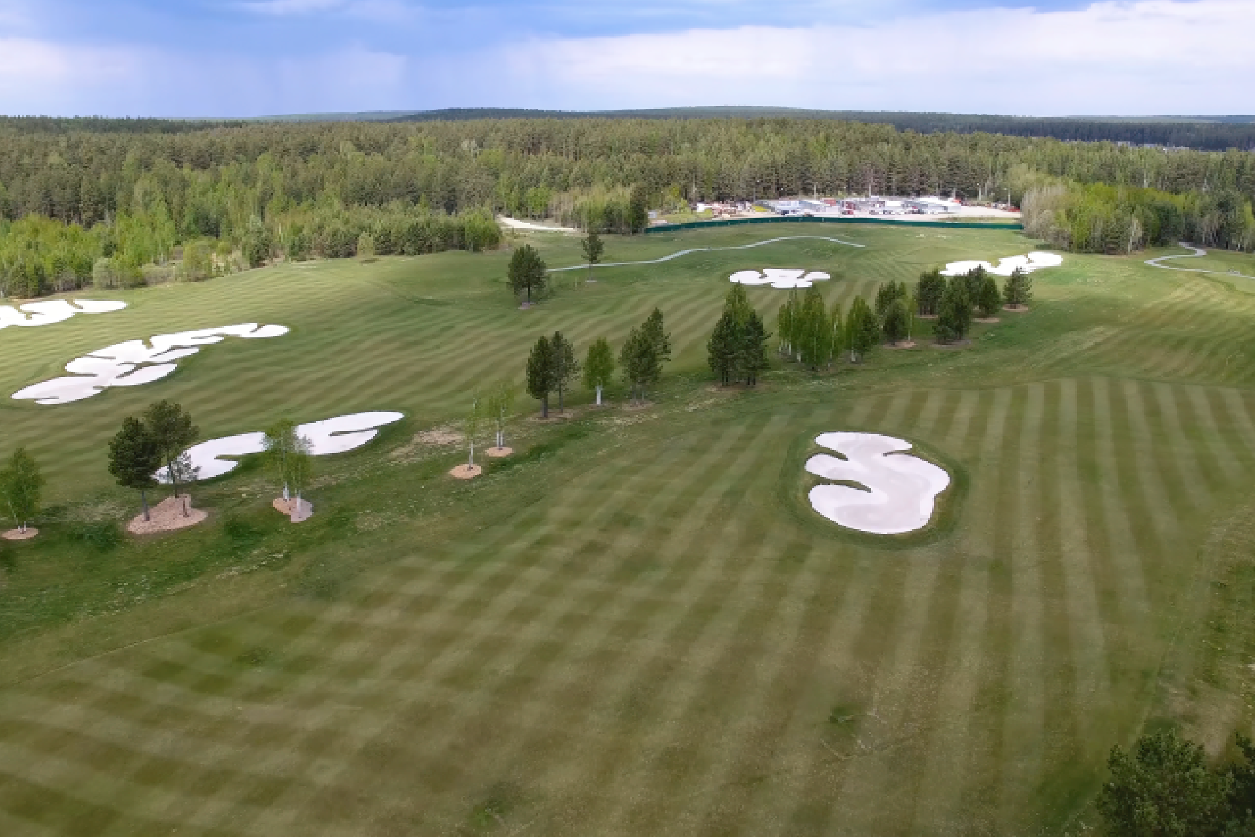 An aerial shot of a beautifully designed championship golf course, ready for a tournament