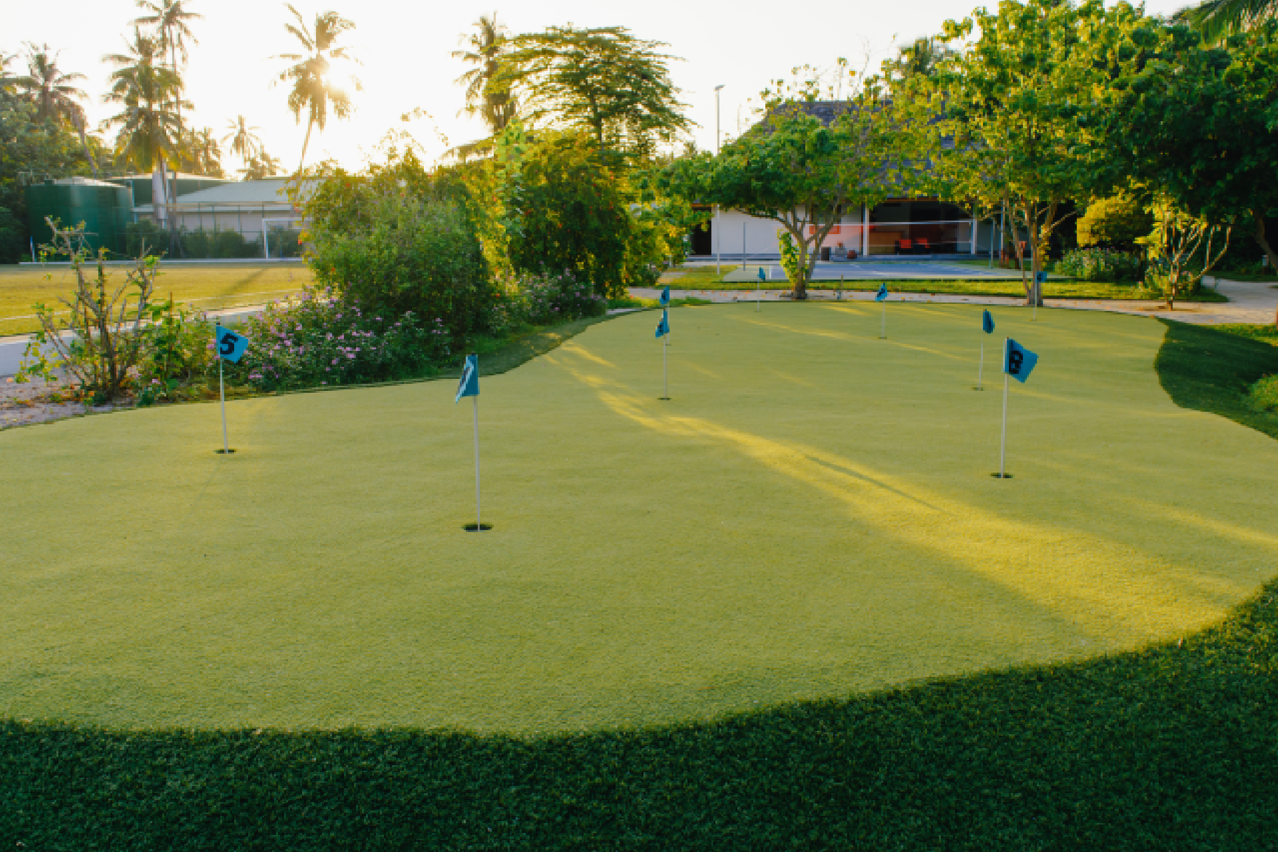 An aerial view of a compact 9-hole golf course nestled within a small piece of land