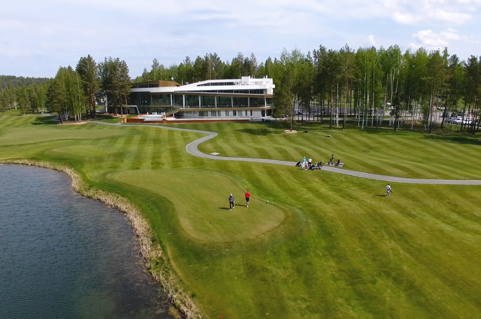 An aerial view of a modern golf course featuring flexible tee boxes and naturalized waste areas.