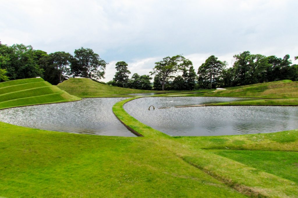 A modern golf course showcasing native vegetation and water features