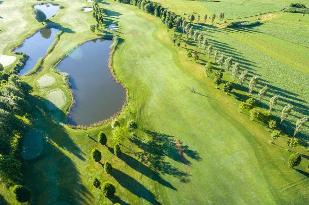 Sustainable golf course featuring native grasses and a naturalized water hazard