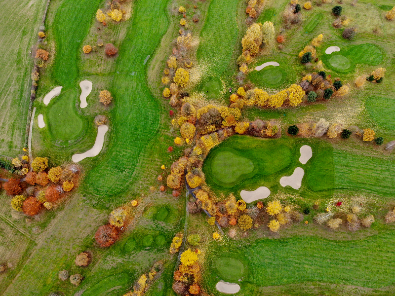 A golf course master plan highlighting preserved wildlife corridors and native planting zones integrated with the fairways.