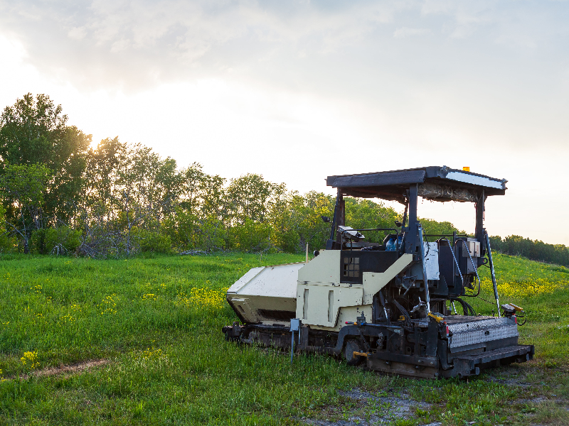 Heavy machinery performing detailed grading on a golf course fairway