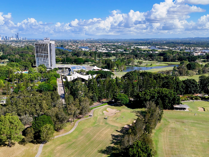 Panoramic view of multiple tiered tee complexes aligned precisely down an architectural fairway corridor